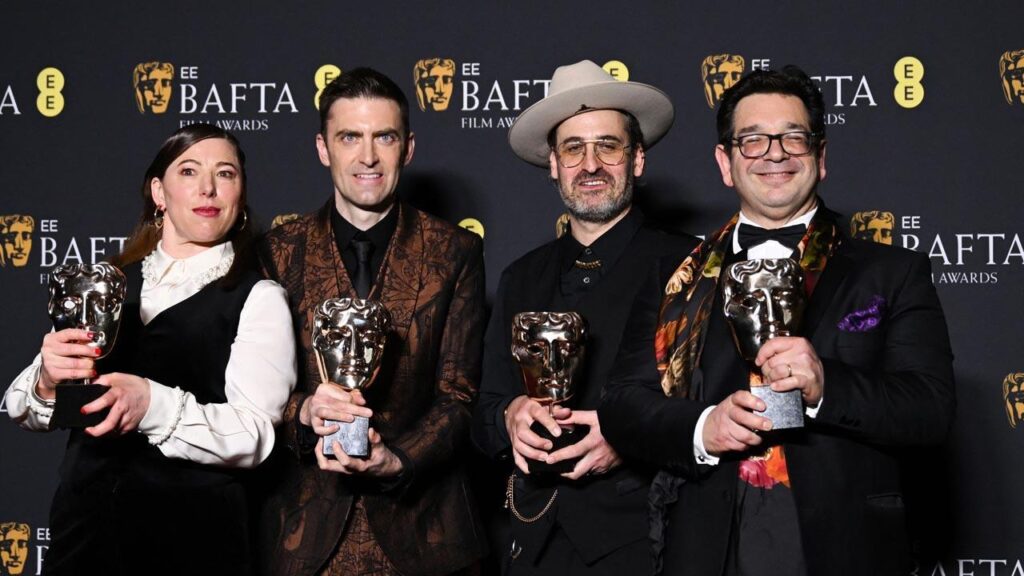 Swiss film director Ian Bonhote, US film producer Peter Ettedgui, British documentary producer Lizzie Gillett and film producer Robert Ford pose with the award for Best documentary for "Super/Man : The Christopher Reeve Story" during the BAFTA British Academy Film Awards ceremony at the Royal Festival Hall, Southbank Centre, in London.